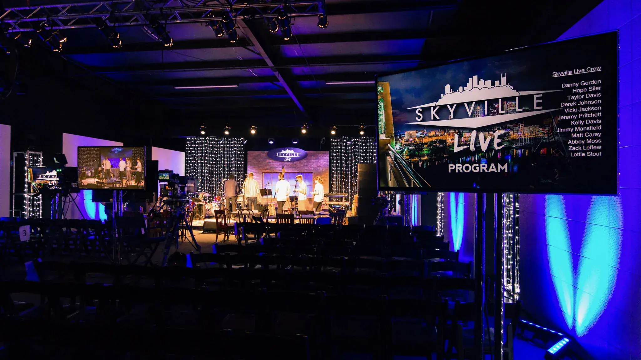 Blue concert stage with dramatic beam rigging