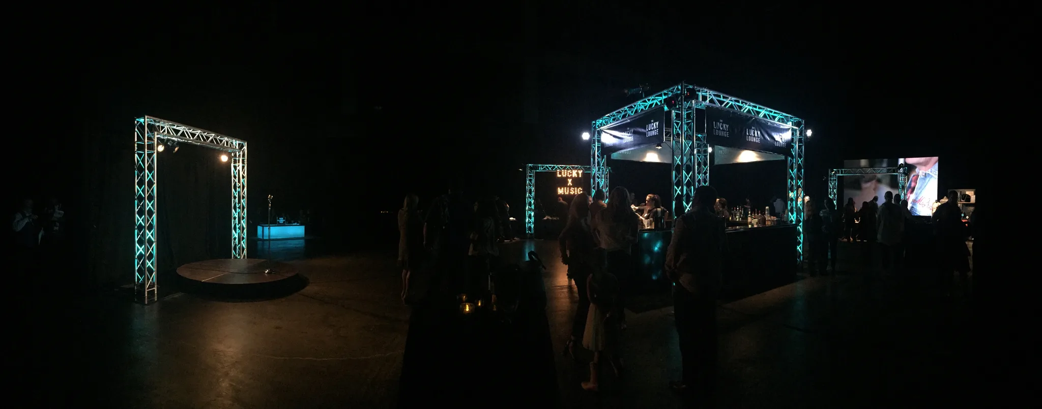 Outdoor festival stage with cyan truss rigging