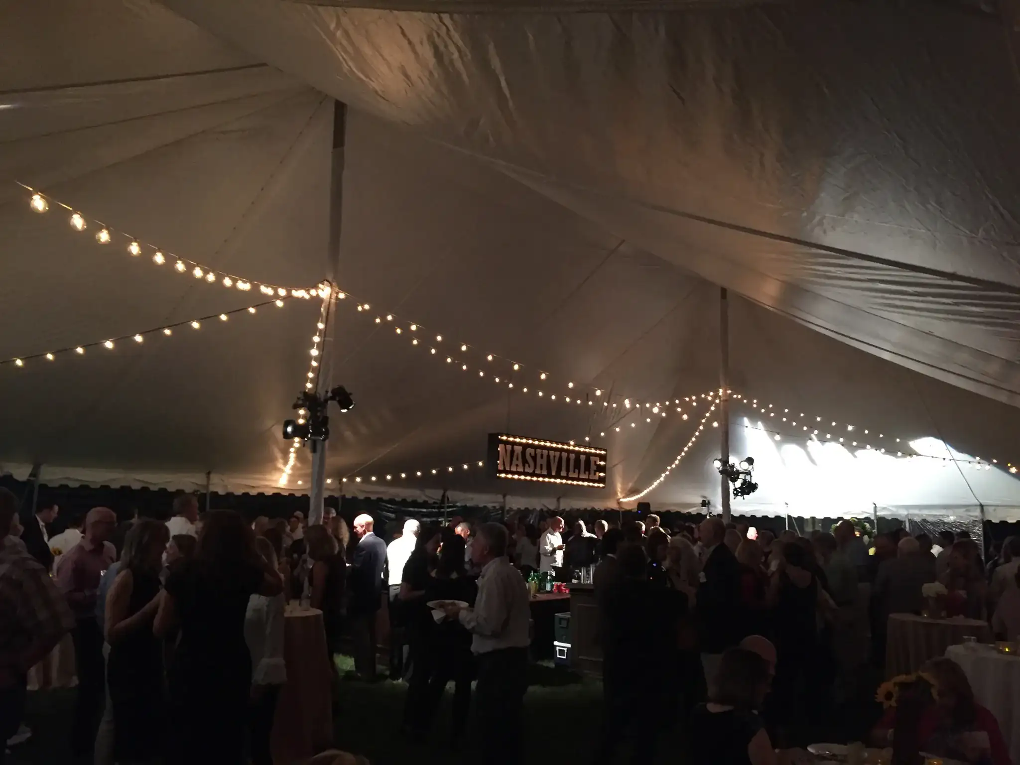 Outdoor festival with multi-colored stage lighting
