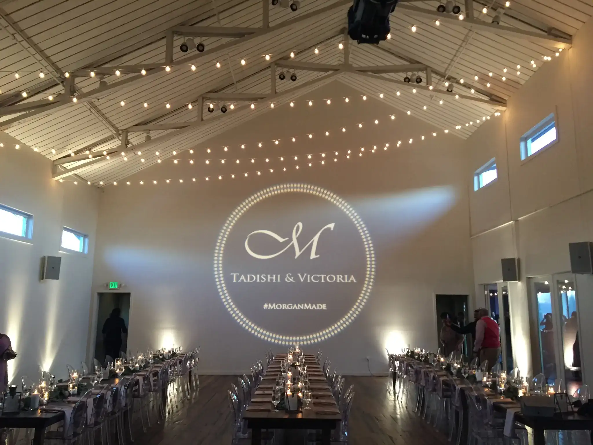 Wedding hall with string lights and custom monogram gobo projection