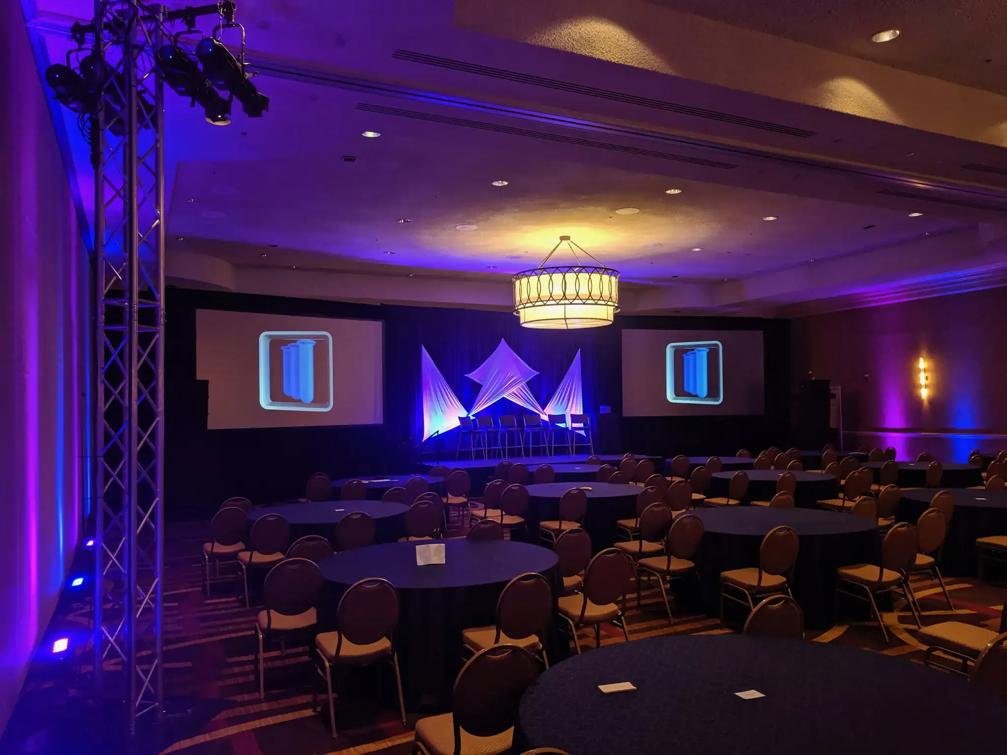 Corporate conference hall with purple and blue uplighting