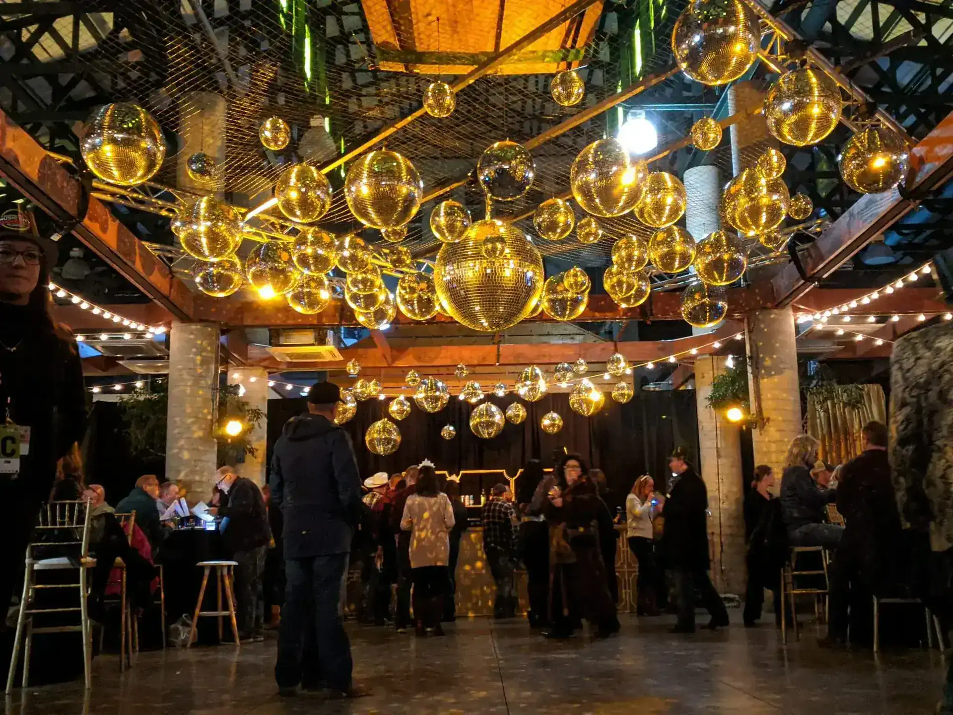 Charity gala with gold accent lighting and mirror balls