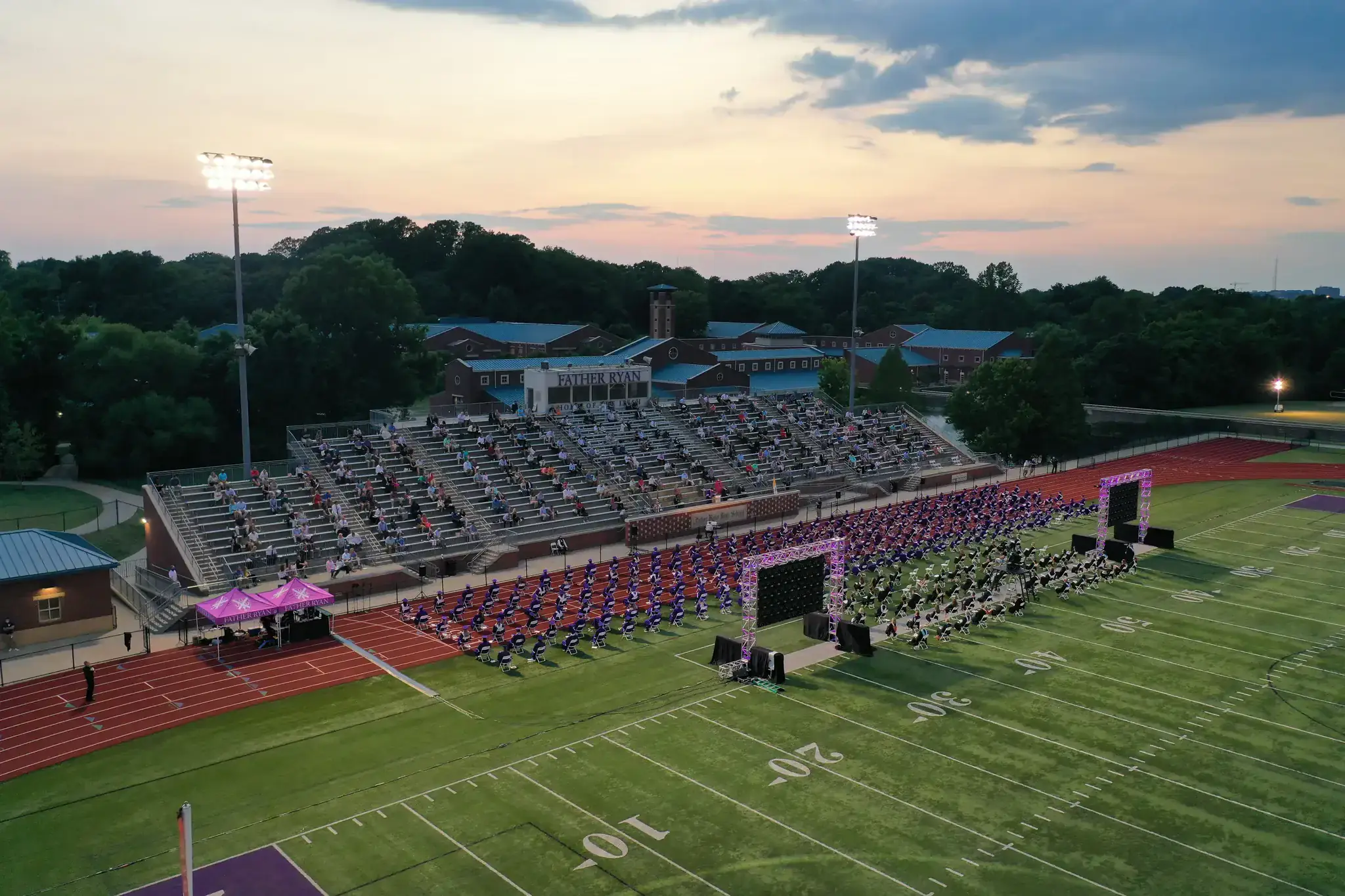 Large outdoor stadium stage with pink wash lighting