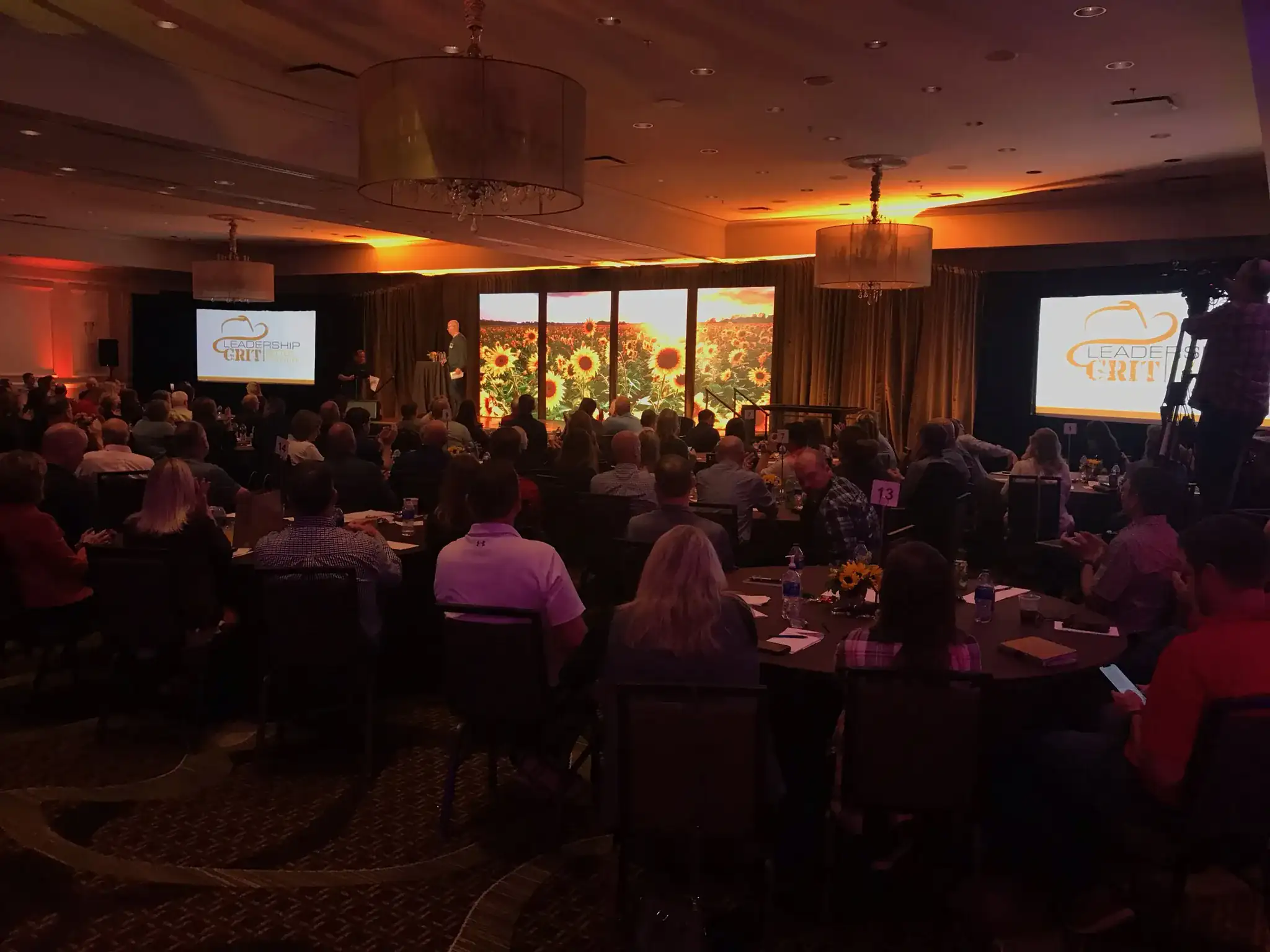 Corporate dinner with warm orange ceiling uplighting